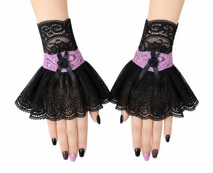 kleine Stulpen, Manschetten im gothic lolita Stil, rosa schwarz in Handarbeit genäht in Deutschland, in 7 Größen für Damen erhältlich, hier an Damenhänden nebeneinander drappiert fotografiert mit kunstvoll gestalteten Fingernägeln auf weißem Hintegrund, professionelle Studio Beleuchtung. Unikat von Mouska Alfar. handgefertigt in Deutschland.