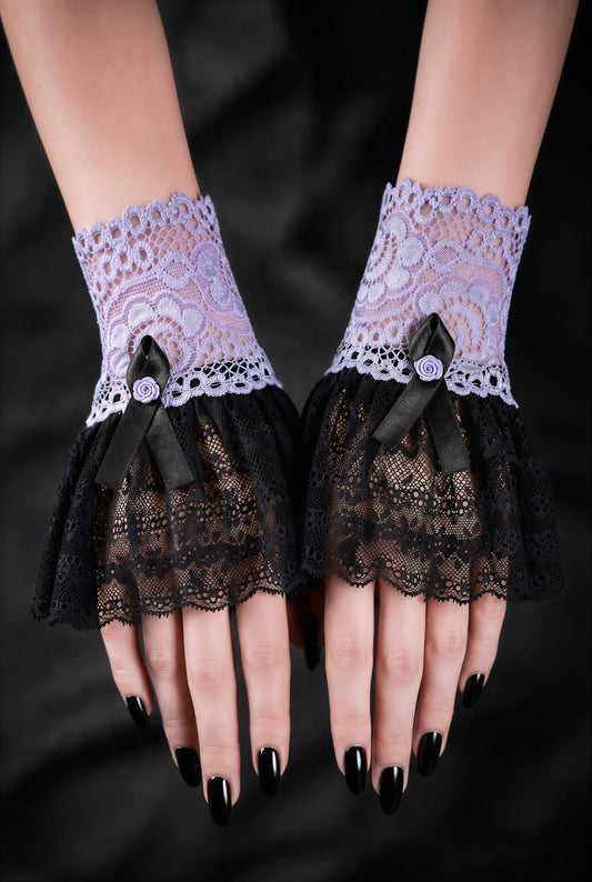 Sweet Lolita Gothic Manschetten aus Spitze in flieder schwarz, fotografiert an einem Paar Damen Hände, die auf schwarzen Stoff nebeneinander liegen. Schwarz lackierte Fingernägel. Kleine Armstulpen mit Satin Rose verziert, Handgefertigt in Deutschland.