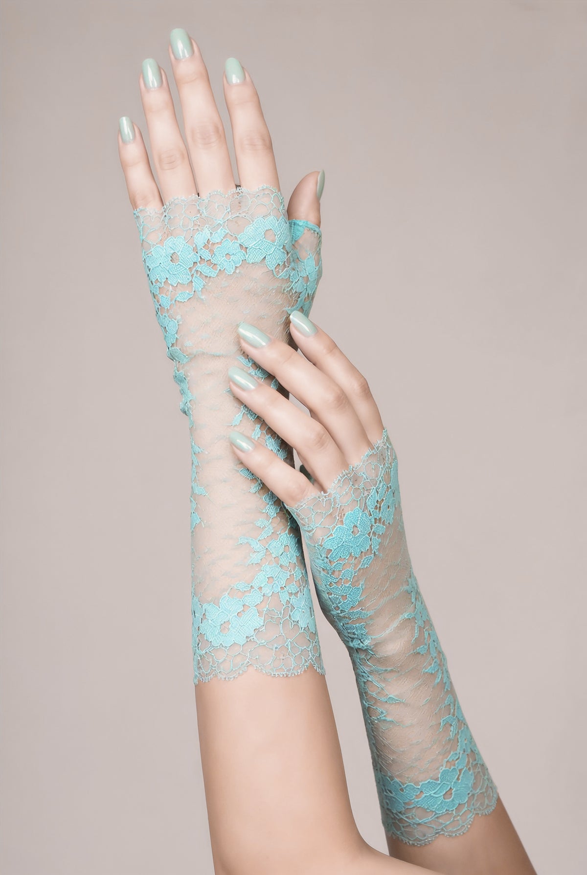 ein weiteres Modellfoto der langen türkis farbigen, zarten, edlen Spitzen handschuhe. Die eine Hand scheint den Arm der anderen visuell herunter zu streichen. Schönes Vintage Hochzeits Foto. Designerin: Mouska Alfar aus Hamburg, Deutschland. Handgefertigt.