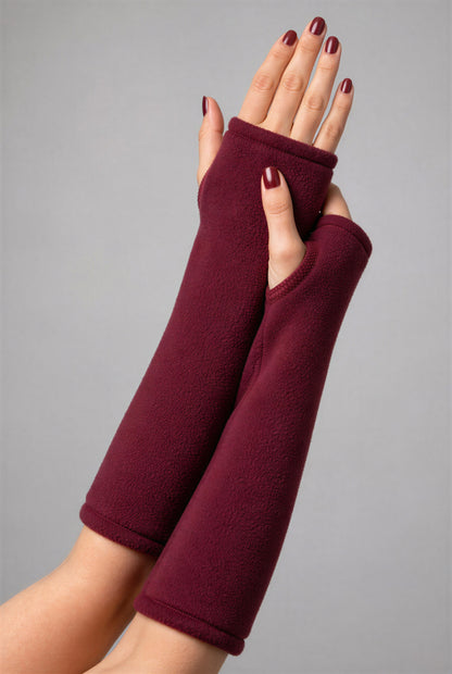 Fleece Stulpen an zwei ineinander liegenden Frauenarmen mit lackierten Fingernägeln in weinrot.